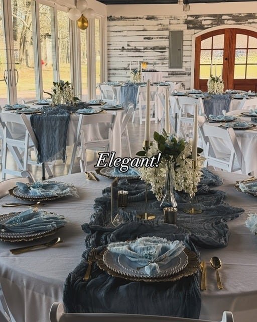 Close table setting with slate linens, gold flatware and white florals
